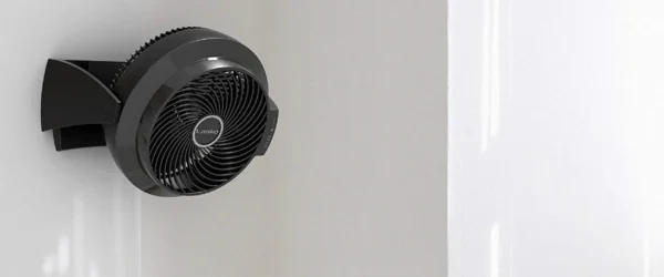 Wall-mounted bladeless cooling fan installed in a modern minimalist living room.