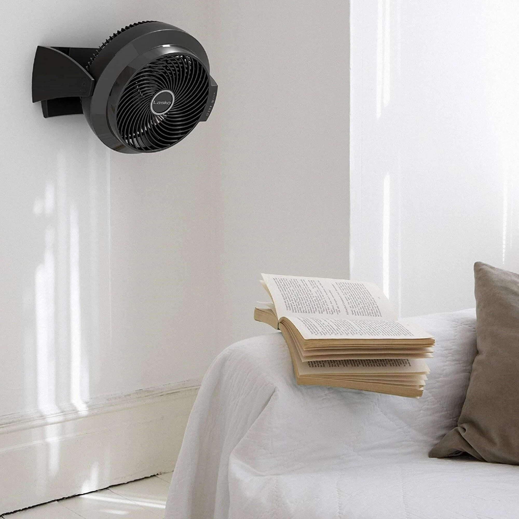 Wall-mounted bladeless cooling fan installed in a modern minimalist living room.