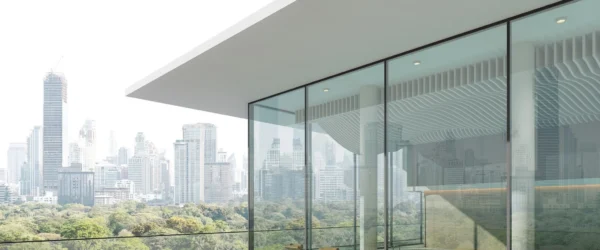 Modern steel parapet wall design on a rooftop terrace featuring glass panels, perforated steel screens, and contemporary architectural detailing.